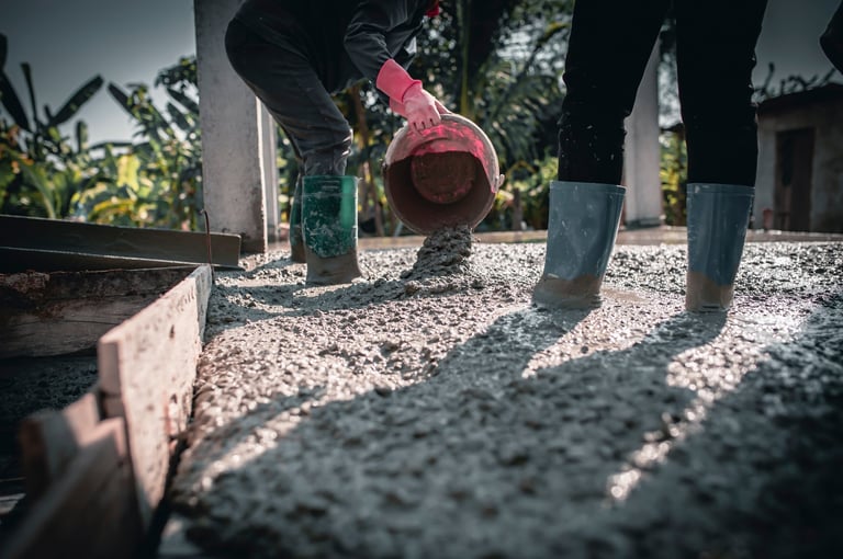 Man pouring concrete for surface adjustment